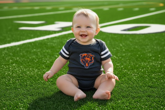 Baby boy in Bears striped onesie - richer green field