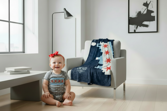 Baby girl with red bow and correct Chicago neighborhoods blanket