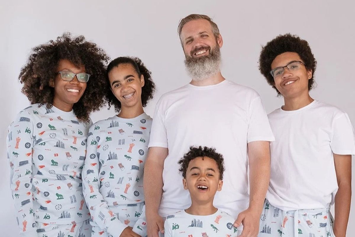 a group of people of mixed ages and genders wearing chicago themed pyjamas